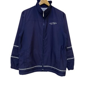 May include: Navy blue Courr&egrave;ges sport futur jacket with a full-length zipper and a stand-up collar. The jacket features white stripes with text on the sleeves and bottom hem. The brand name is printed in white on the chest.