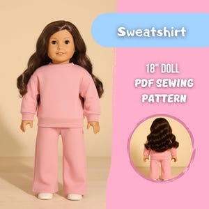 May include: A doll wearing a light pink sweatshirt and matching pants. The doll has long brown hair and is wearing white shoes. Text on the image reads "Sweatshirt" and "18" DOLL PDF SEWING PATTERN". A smaller image of the doll in the outfit is in a pink circle.