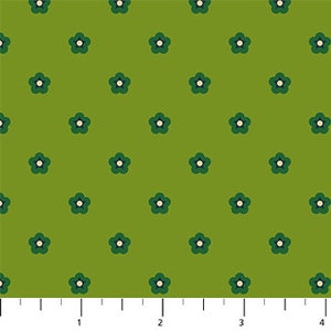 May include: Green fabric with a repeating pattern of small, stylized flowers. Each flower has dark green petals and a cream-colored center. The background is a solid, lighter shade of green. The ruler at the bottom shows measurements in inches.