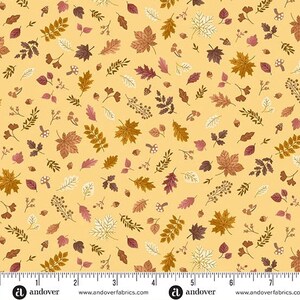 May include: A fabric with a repeating pattern of autumn leaves, acorns, and small mushrooms in shades of brown, gold, and burgundy on a light yellow background. The design includes various leaf shapes and botanical elements, creating a seasonal theme.