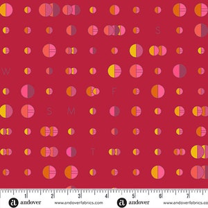 May include: A red fabric with a repeating pattern of half-circles in shades of pink, orange, and yellow. The letters W, F, S, M, and T are interspersed among the circles. The fabric has a ruler along the bottom edge.
