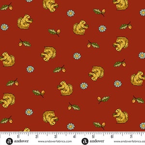 May include: A red fabric with a repeating pattern of squirrels, acorns, and leaves. The squirrels are yellow and brown and are holding acorns. The acorns are brown and the leaves are green.