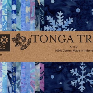 May include: A pack of 12 5-inch by 5-inch fabric squares featuring a blue and white batik pattern with snowflakes. The fabric is 100% cotton and made in Indonesia. The pack is labeled "TONGA TREATS™" and "TIMELESS TREASURES".