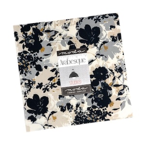 May include: A square fabric piece with a floral pattern in navy, gray, and gold on a cream background. The fabric is labeled "moda Arabesque" with a Studio 314 logo.