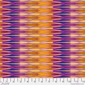 May include: A fabric swatch featuring a repeating horizontal ikat-style pattern in shades of deep purple, magenta, bright orange, and soft peach. A white ruler measuring 12 inches is visible along the bottom edge with FreeSpirit branding.