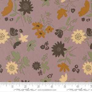 Può includere: Un tessuto color malva con un motivo floreale ripetuto di fiori marrone scuro, giallo senape e giallo pallido, insieme a foglie e steli verde salvia. Un metro a nastro bianco è visibile nella parte inferiore, indicando una lunghezza di 18 cm.