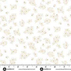 May include: White fabric with a repeating pattern of small, beige floral clusters. The flowers have delicate outlines and are scattered across the surface. A ruler is at the bottom of the image, with the Andover logo and website address.