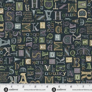 May include: A dark navy blue fabric featuring a repeating pattern of ornate, decorative letters in shades of cream, sage green, and muted purple. A white ruler at the bottom shows the fabric width spans approximately 7 inches across the design.