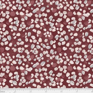 May include: A fabric featuring a burgundy backdrop adorned with a pattern of white, grey, and burgundy brushstrokes. The brushstrokes are oval and irregular. A ruler along the bottom edge shows measurements in inches, equivalent to cm.