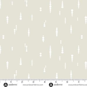 May include: A light gray fabric with a white repeating pattern of vertical lines of circles. The fabric is marked with a ruler in inches and the text "andover" and "www.andoverfabrics.com".
