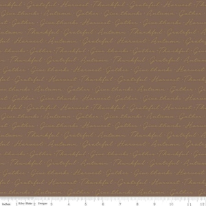 May include: Brown fabric featuring a repeating pattern of cursive text in a lighter brown hue. The words include "Thankful," "Grateful," "Harvest," and "Give thanks." Ideal for autumn-themed crafts.