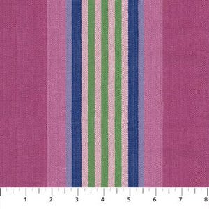 May include: Close-up of a fabric with vertical stripes. The stripes alternate between shades of pink and a central group of stripes in blue, green, and light pink. The fabric has a textured appearance, and a ruler is visible at the bottom, showing measurements in inches.