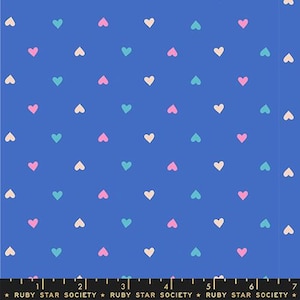 May include: Blue fabric with a repeating pattern of small hearts in pastel colors: pink, teal, and cream. The fabric has a ruler along the bottom edge with the text "RUBY STAR SOCIETY".