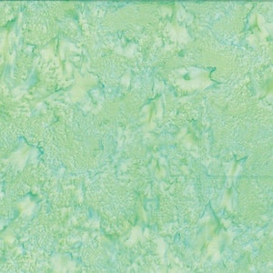 May include: A green and white batik fabric with a mottled, marbled pattern.