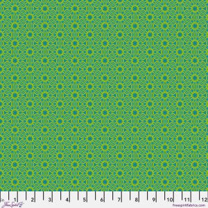 May include: A fabric swatch featuring a repeating geometric star pattern in lime green and teal blue. A white ruler is positioned along the bottom edge, showing a scale of 12 inches, with the text FreeSpirit and freespiritfabrics.com printed.
