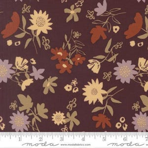 May include: A dark maroon fabric featuring a repeating floral pattern with cream, light purple, and rust-coloured flowers and leaves. A white ruler is visible at the bottom, showing a measurement scale of up to 18 cm for the fabric design.