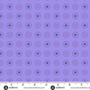 May include: A repeating pattern of stylized floral designs on a lavender background. Each flower has a dark purple center with radiating lines and smaller purple dots. The fabric is marked with a ruler along the bottom edge.