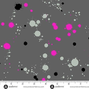 May include: A fabric with a gray background featuring a pattern of paint splatters in black, light gray, and bright pink. The fabric has a ruler along the bottom edge with the word "andover" and website address.