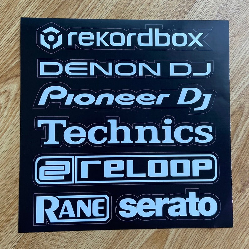 May include: A black background with white text logos for popular DJ software and hardware brands, including Rekordbox, Denon DJ, Pioneer DJ, Technics, Reloop, and Rane Serato.