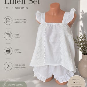 May include: A white linen set consisting of a sleeveless top with ruffled shoulder straps and vertical eyelet lace trim, paired with matching shorts featuring a ruffled hem. The text reads PDF SEWING PATTERN, Linen Set, TOP & SHORTS, and SANTASEE PATTERNS.