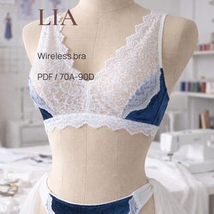 May include: A wireless bra and matching underwear set. The bra features white lace over a blue velvet base, with delicate lace trim. The set is displayed on a mannequin. Text on the image reads "LIA" and "Wireless bra PDF / 70A-90D."