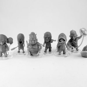 May include: Set of seven small, grey, 3D printed figurines of various characters. The figurines are standing on clear plastic bases.