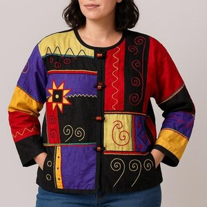 May include: A patchwork jacket with a round neckline and long sleeves. The jacket features a vibrant mix of colors including black, red, yellow, and purple, with embroidered details and wooden button closures. The jacket has two pockets.
