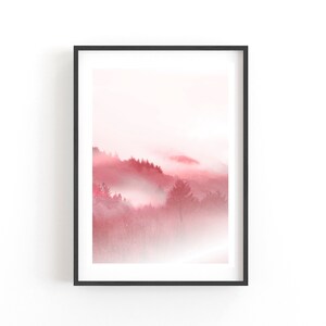 May include: A framed print of a misty forest scene in shades of pink and white. The trees are silhouetted against the fog, creating a dreamy and ethereal atmosphere.