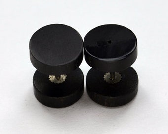 May include: A pair of black double-sided ear gauges. Each gauge has a smaller black disc on top of a larger black disc.