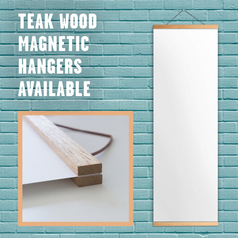May include: A white poster hanging on a blue brick wall with a wooden frame and magnetic hangers. The poster is blank and the frame is made of natural wood. The text "TEAK WOOD MAGNETIC HANGERS AVAILABLE" is printed in white on the wall.
