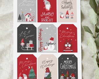 May include: A sheet of Christmas gift tags with various designs. The tags feature illustrations of gnomes, snowmen, Christmas trees, and holiday phrases like "Merry Christmas" and "Happy Holidays" in red, gray, and white.