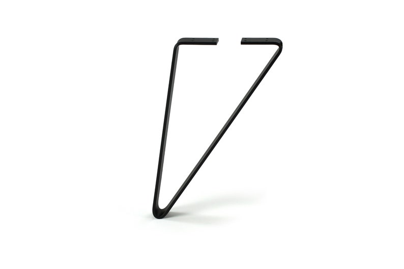 May include: A single black hairpin table leg, angled and curved at the bottom. The leg has two flat mounting plates at the top for easy attachment. This furniture component is ideal for DIY projects and adding a modern touch to tables.