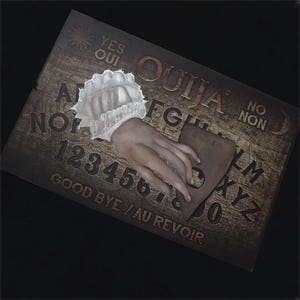 Victorian seance mourning hand on Ouija board oddity art