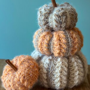 Small, medium, and large crochet pumpkins made with bulky yarn, ribbing, and puff stitch, perfect for Thanksgiving table decor