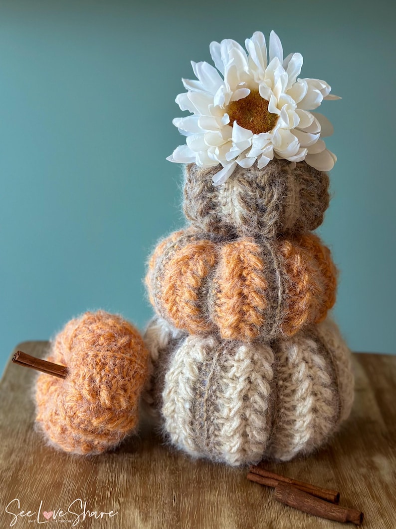 Small, medium, and large crochet pumpkins made with bulky yarn, ribbing, and puff stitch, perfect for Thanksgiving table decor