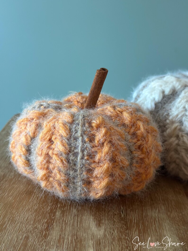 Close-up of ribbed crochet pumpkin showing puff stitch texture and color-changing yarn technique for handmade autumn decoration