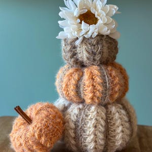 Small, medium, and large crochet pumpkins made with bulky yarn, ribbing, and puff stitch, perfect for Thanksgiving table decor