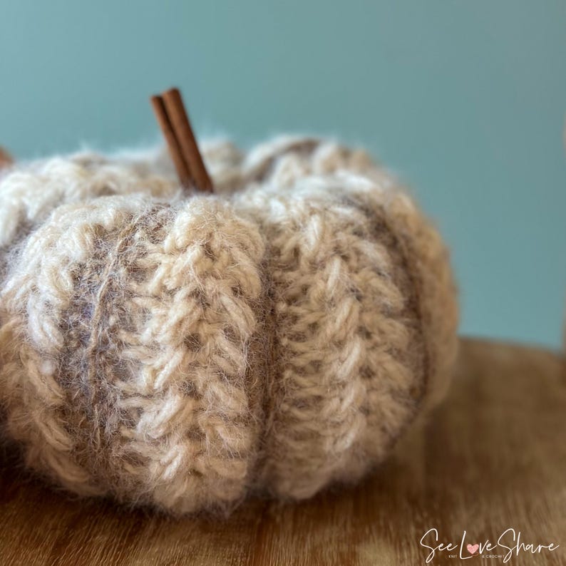 Close-up of ribbed crochet pumpkin showing puff stitch texture and color-changing yarn technique for handmade autumn decoration
