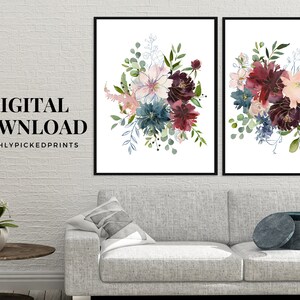 May include: Two framed floral art prints. Each print features a watercolor bouquet with burgundy, blue, and pink flowers, accented by green foliage. The text "DIGITAL DOWNLOAD" and "FRESHLYPICKEDPRINTS" are displayed on the left print.