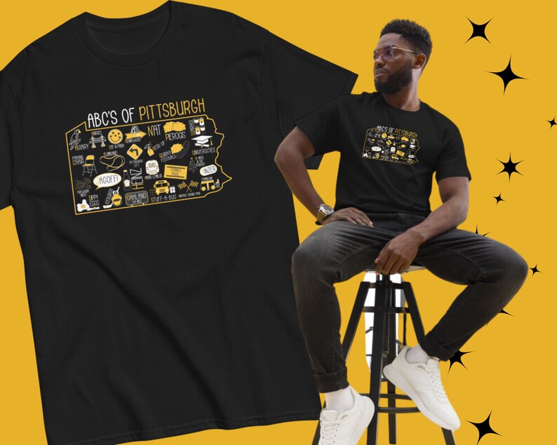 May include: Black t-shirt with a yellow graphic of the state of Pennsylvania with the text "ABC's of Pittsburgh" and various icons representing the city.