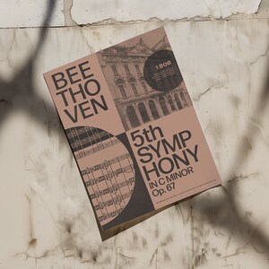 May include: A brown poster with the text "BEETHOVEN 5th SYMPHONY IN C MINOR Op. 67" and a black and white image of sheet music. The poster also includes a black and white image of a building with the year "1808" in a circle.
