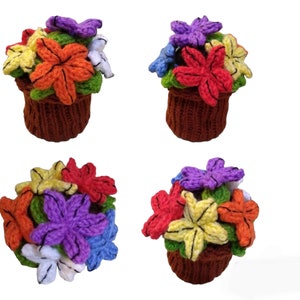 May include: Four crocheted flower pots with colorful flowers. The pots are brown and the flowers are red, orange, yellow, purple, and blue.