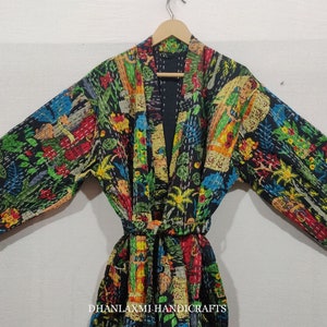May include: A black quilted robe with a colorful floral and geometric print. The robe has a tie belt and long sleeves.