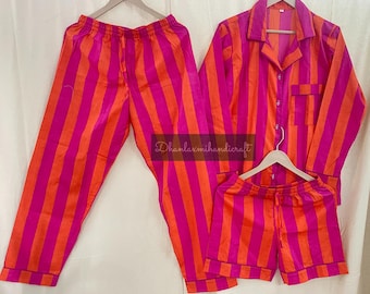 May include: A pink and orange striped pajama set with a long-sleeved shirt and pants. The shirt has a button-up front and a collar.
