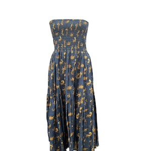 May include: A strapless maxi dress with a blue background and a pattern of gold tigers. The dress has a fitted bodice and a flowing skirt.