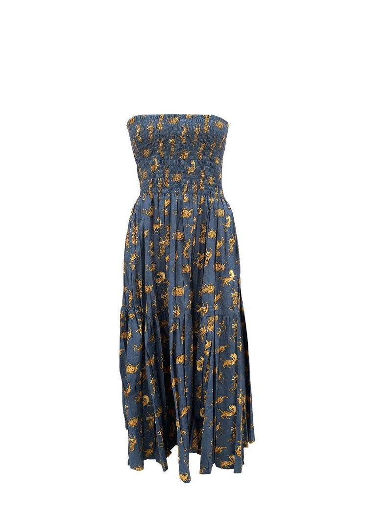 May include: A strapless maxi dress with a blue background and a pattern of gold tigers. The dress has a fitted bodice and a flowing skirt.