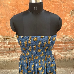 May include: A strapless blue dress with a tiger print. The dress has a fitted bodice and a flowing skirt.
