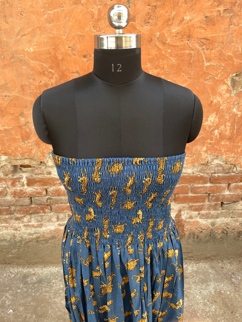 May include: A strapless blue dress with a tiger print. The dress has a fitted bodice and a flowing skirt.