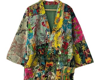 May include: A colorful patchwork kimono-style robe with a floral and patterned design. The robe features a variety of colors, including yellow, pink, green, and blue. It has a relaxed fit with wide sleeves and pockets. The robe is hanging on a wooden hanger.
