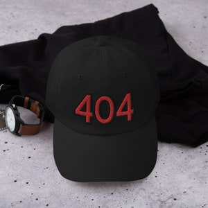 May include: A black baseball cap with a red embroidered "404" on the front.